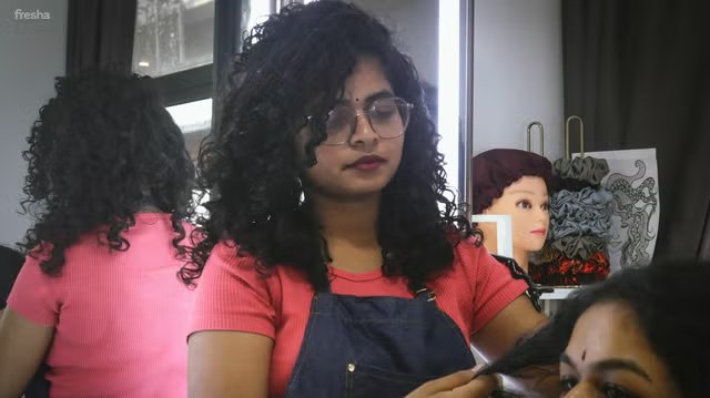 Styling a client's curly hair